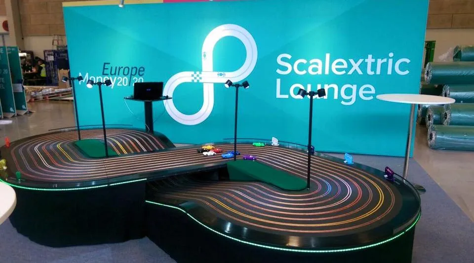 giant scalextric hire giant games events company the best team building events miniracing.com Giant Scalextric 8 lane track for hire being played at an exhibition event